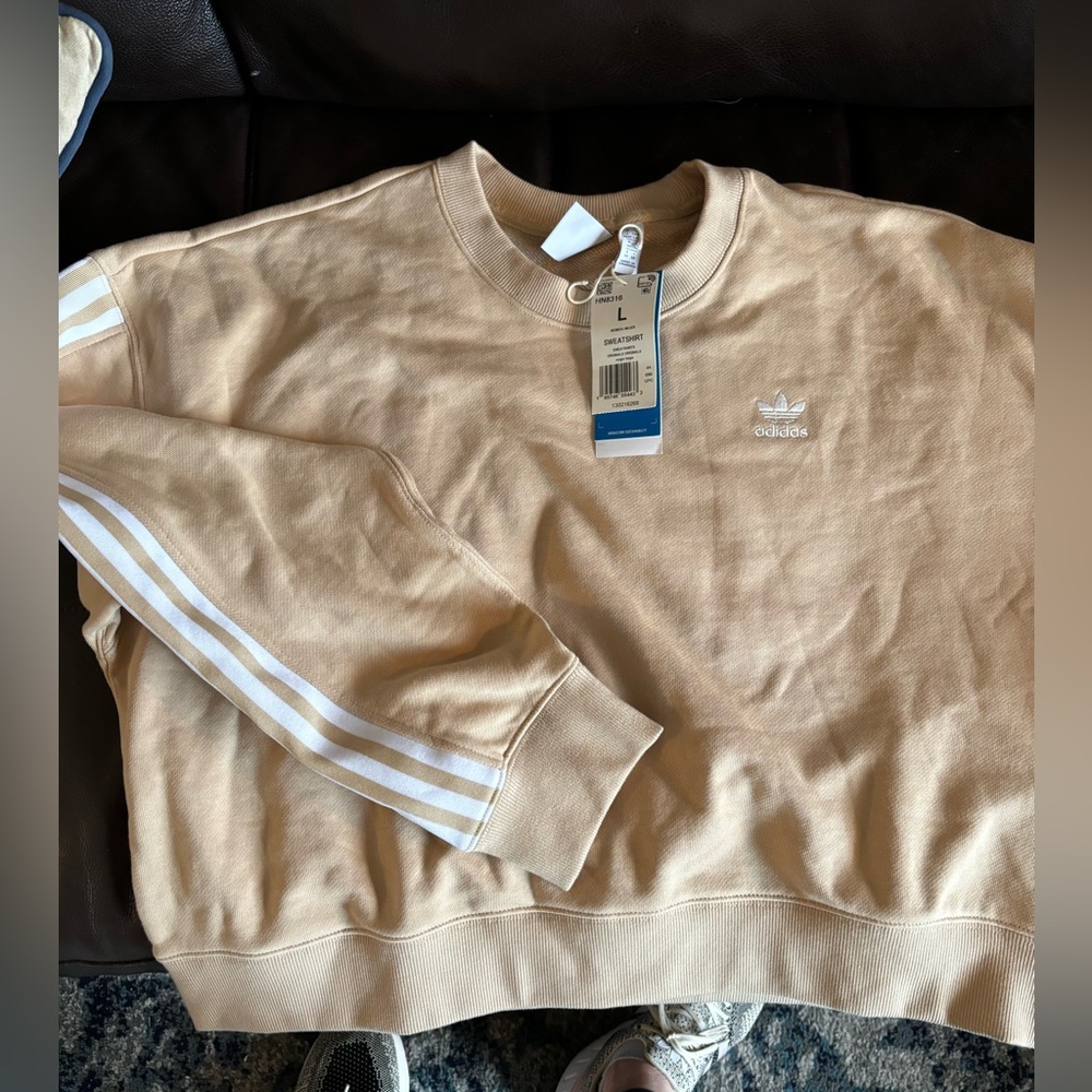 Brand new Adidas women’s sweatshirt . With tags.Tan with white stripes on sleeve